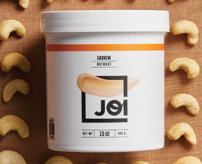 jar of Joi cashew milk base surrounded by raw cashews