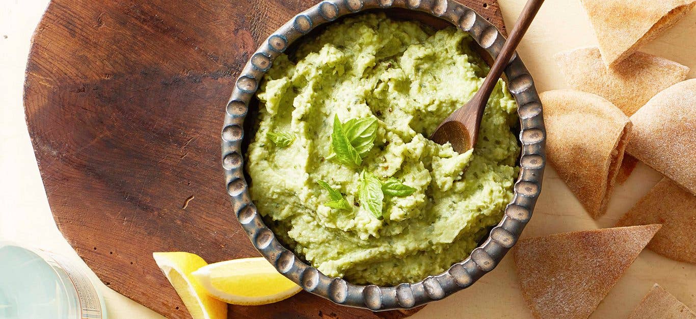 Lima bean hummus - green hummus with basil shown with pita chips