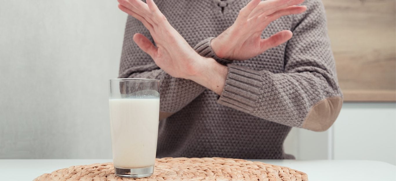 man refusing a glass of milk