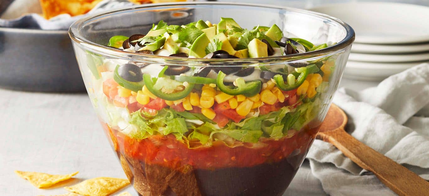 Vegan Mexican 10-Layer Dip Shown in Glass Bowl, which Reveals layers