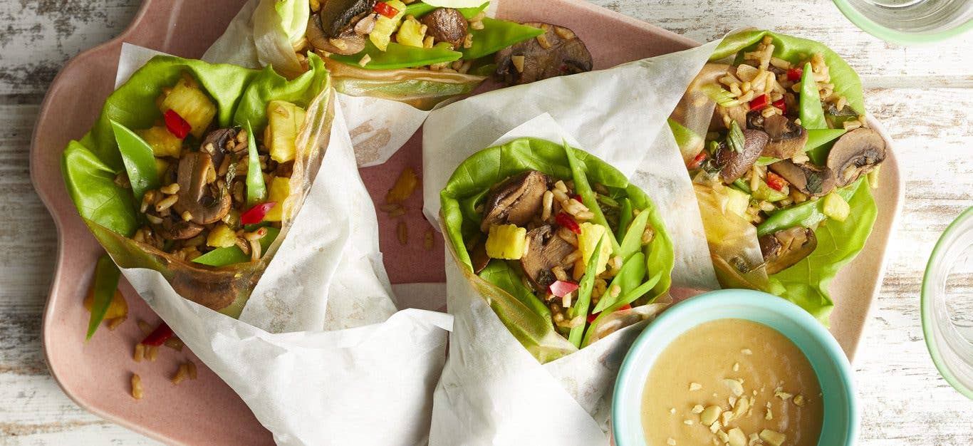 Stir-Fry Wraps with Peanut Dipping Sauce on a pink tray