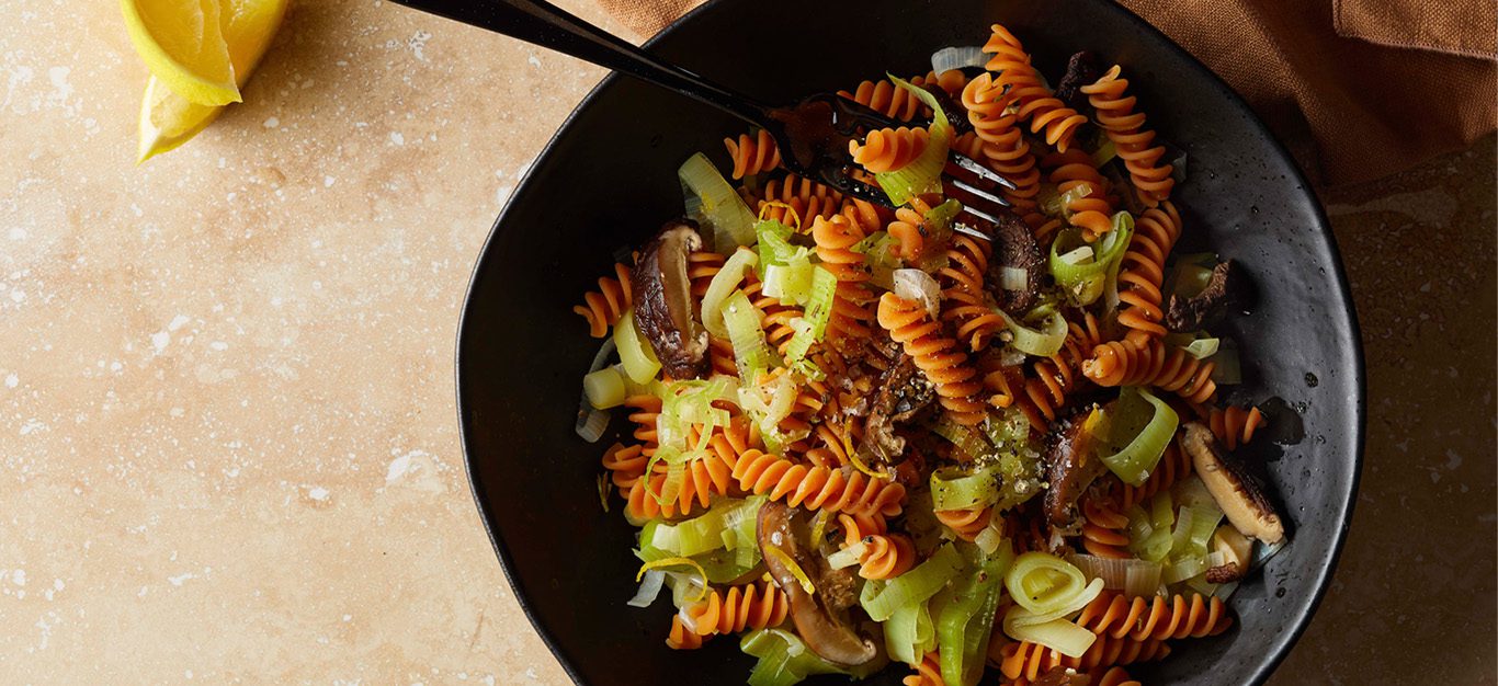 Red lentil rotini pasta with silken leeks and cooked dried shiitake mushrooms