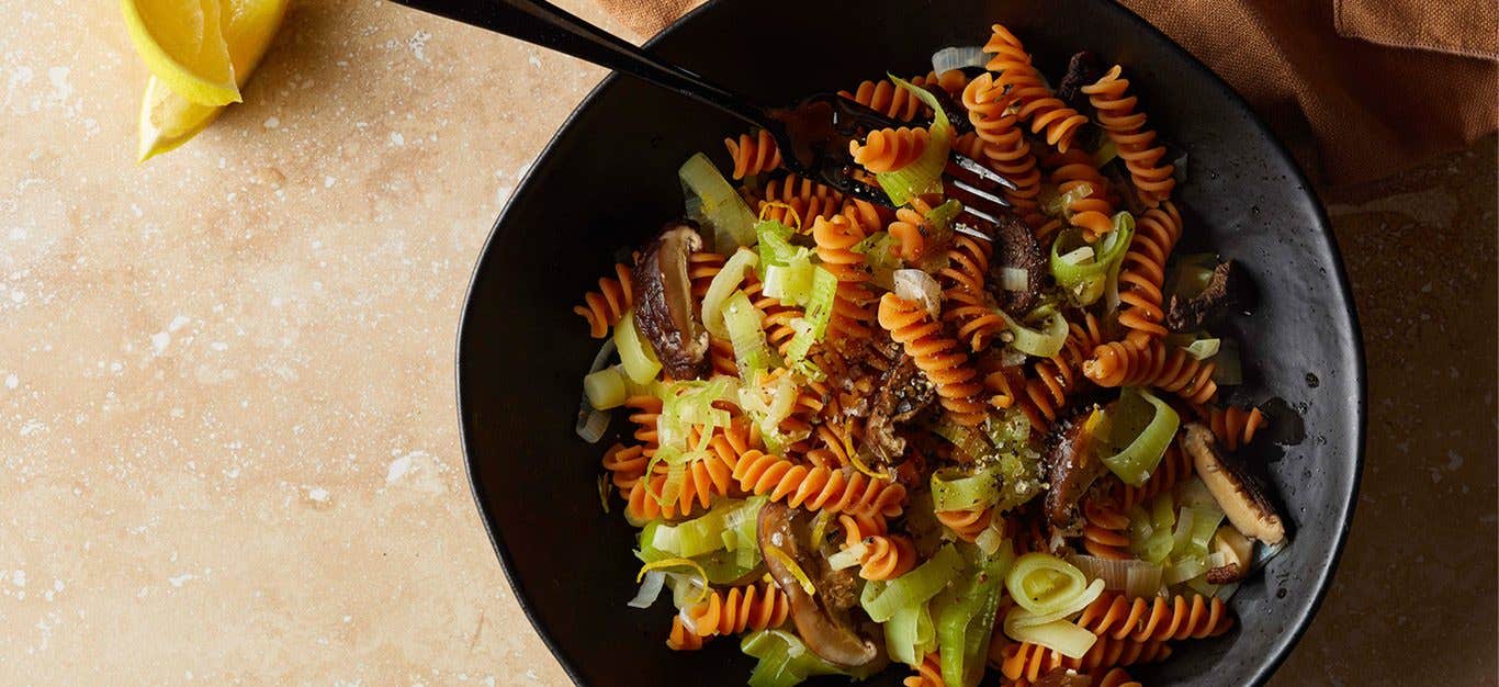 Red lentil rotini pasta with silken leeks and cooked dried shiitake mushrooms