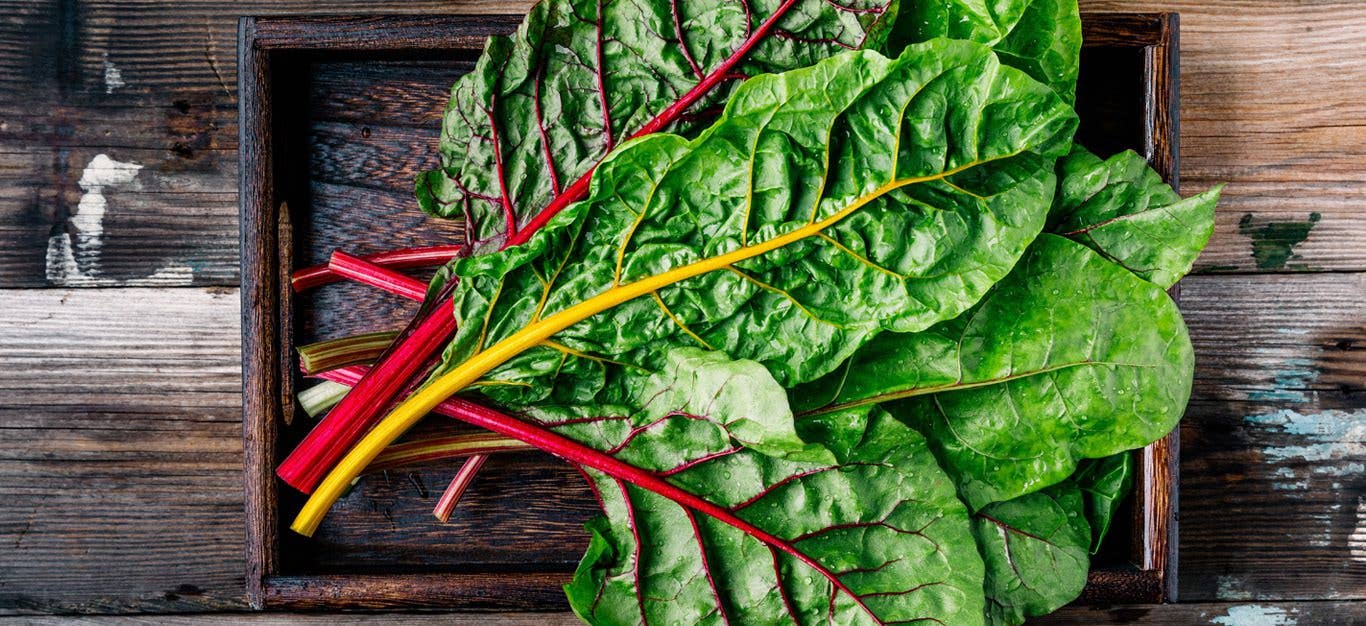 Swiss chard in a wood crate on a wood table