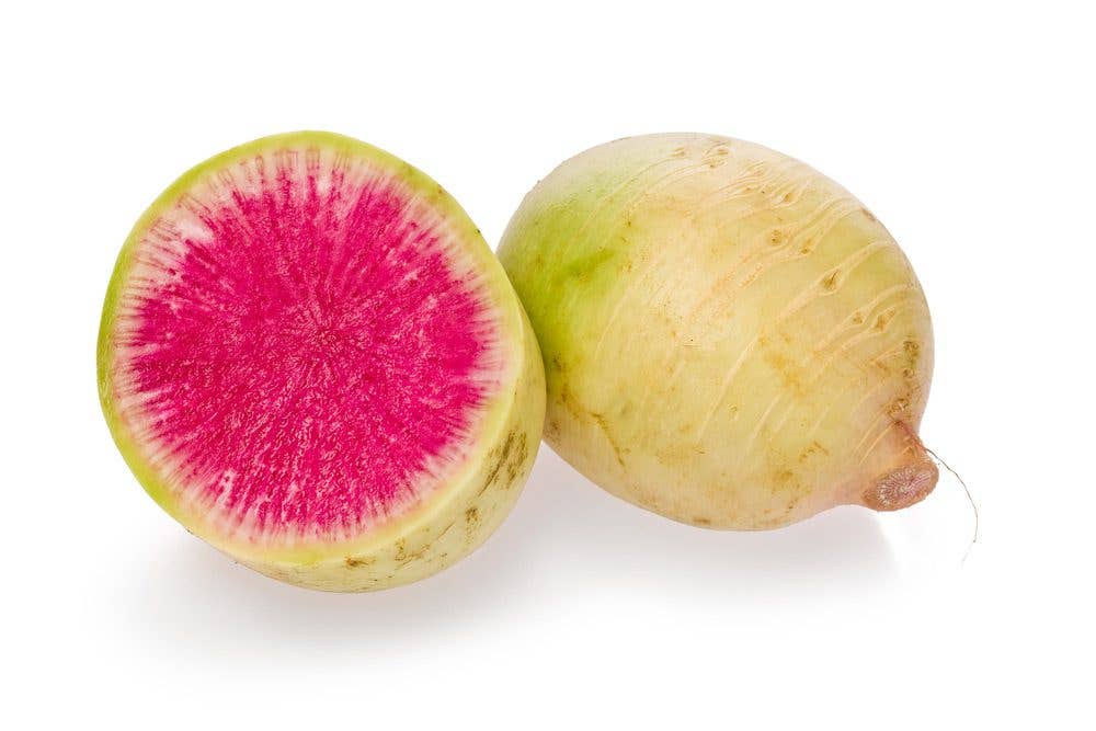 A watermelon radish cut open to reveal pink flesh inside
