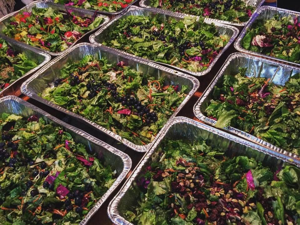 Trays of prepared salad at a Community Solidarity event