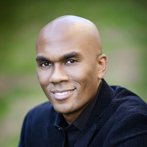 Headshot of Dr. Columbus Batiste against an out of focus green background