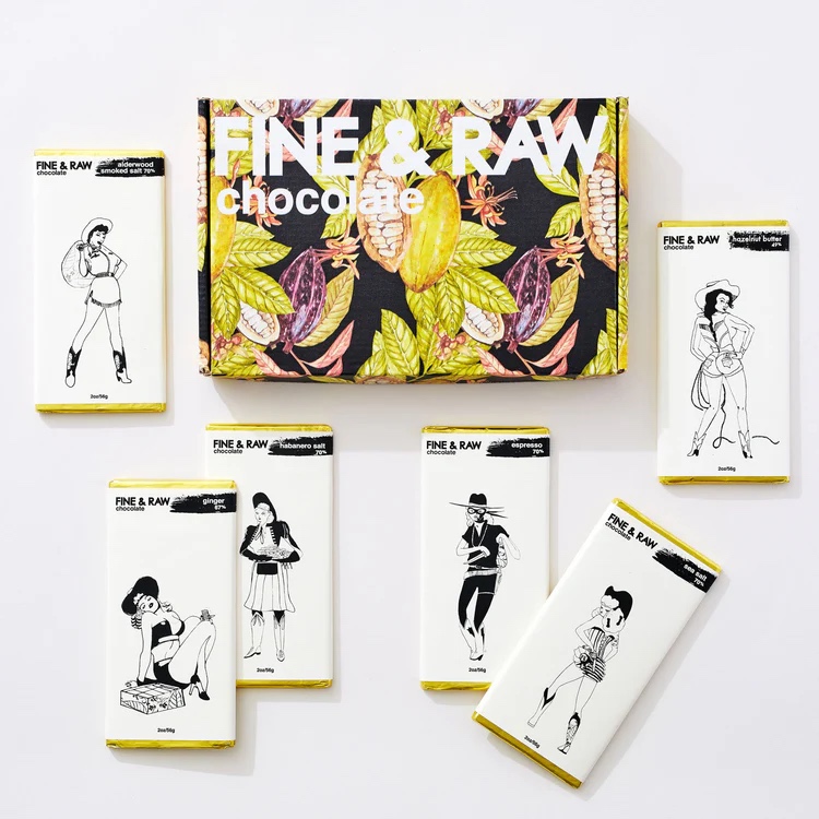 An array of vegan chocolate bars by Fine & Raw, next to a floral gift box that they come in