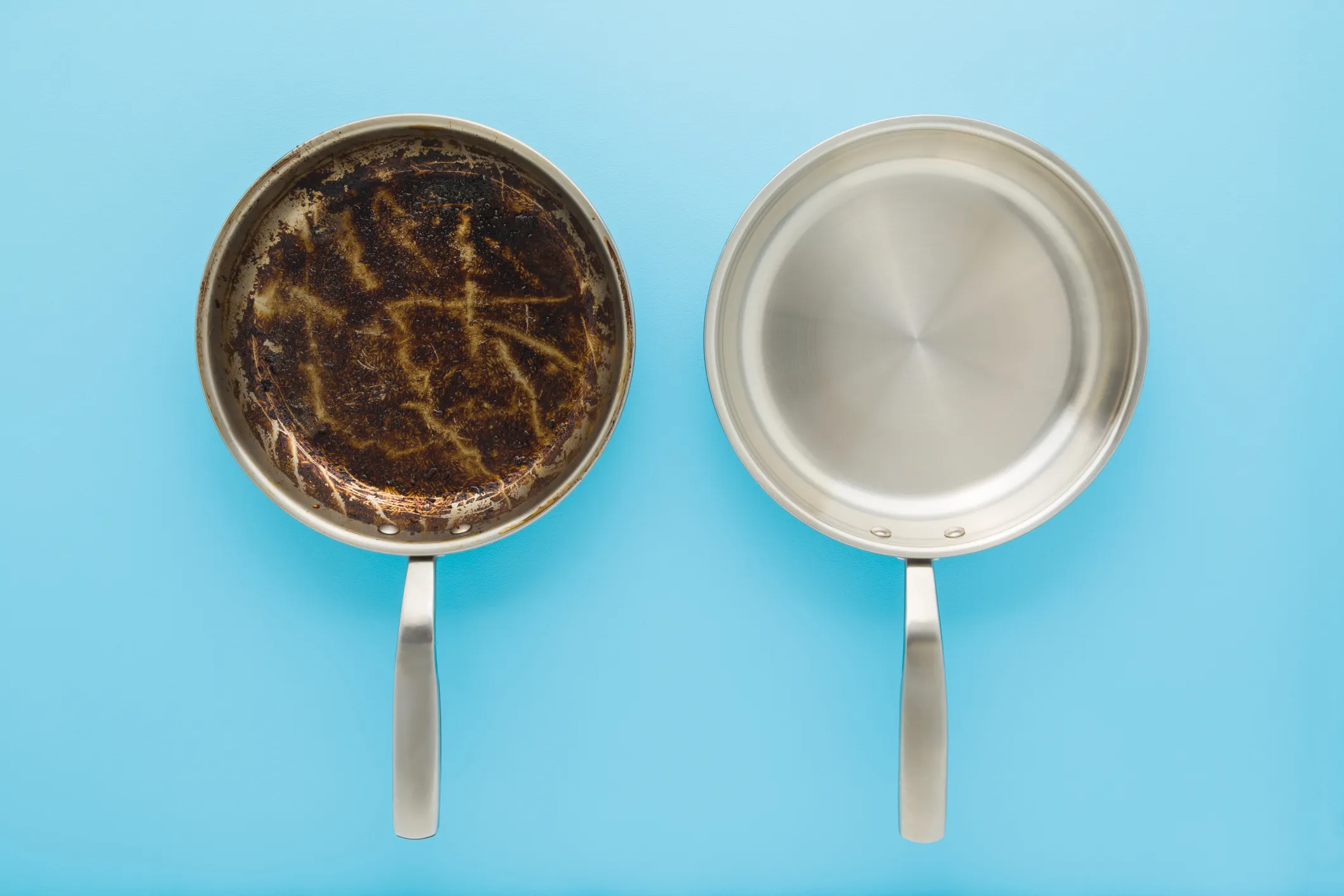 two stainless steel pans - on the left, one is caked in burnt food and grease - on the right is a perfectly clean stainless steel pan without anything sticking to it