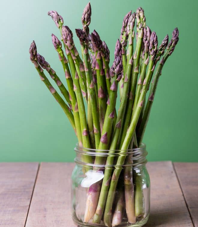 Fresh green asparagus standing in a glass jar