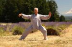 A senior man (Dr. Robert Bacher) practices taiji in a lavender field