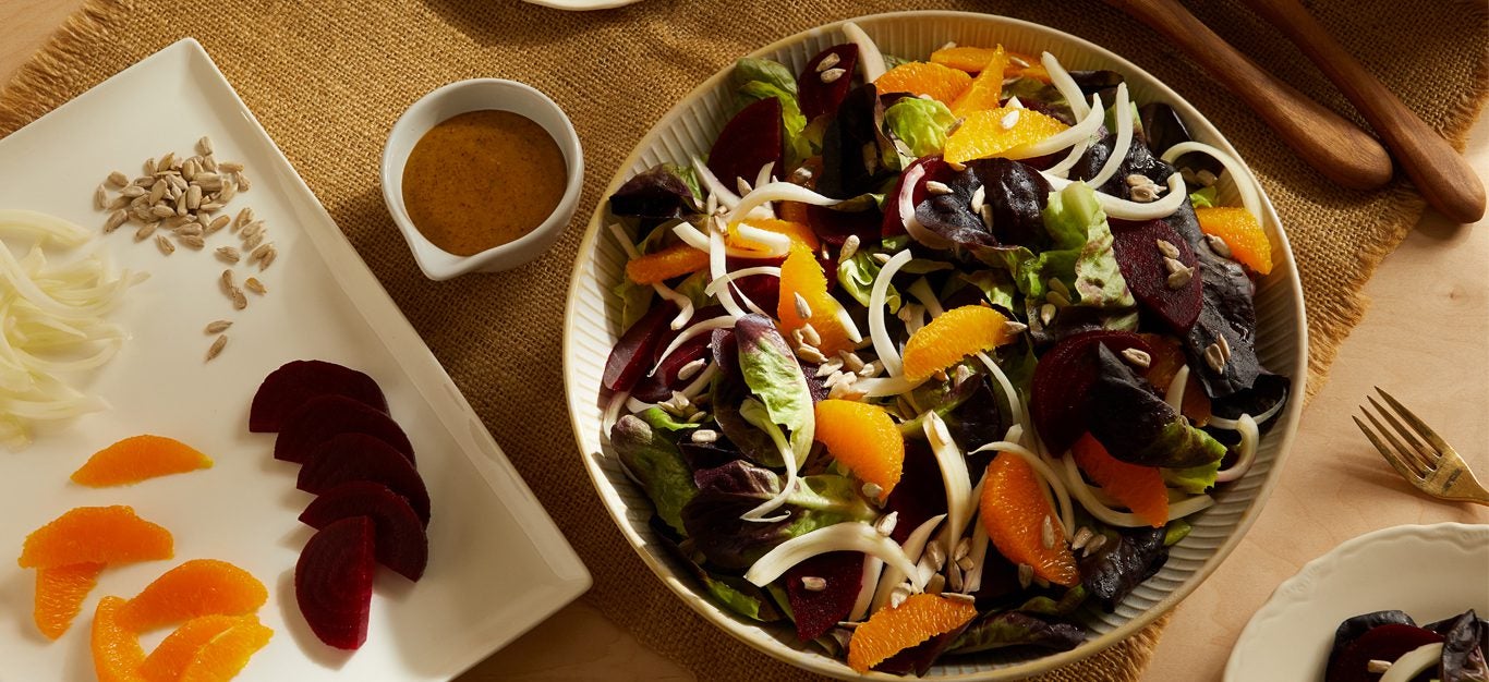Fennel, Orange, and Beet Salad with Maple Mustard Dressing in a shallow serving bowl