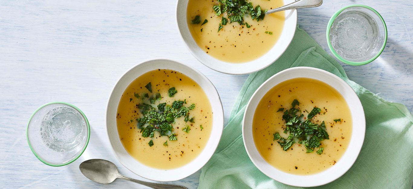 Minted Vichyssoise soup in white bowls on a light gray countertop