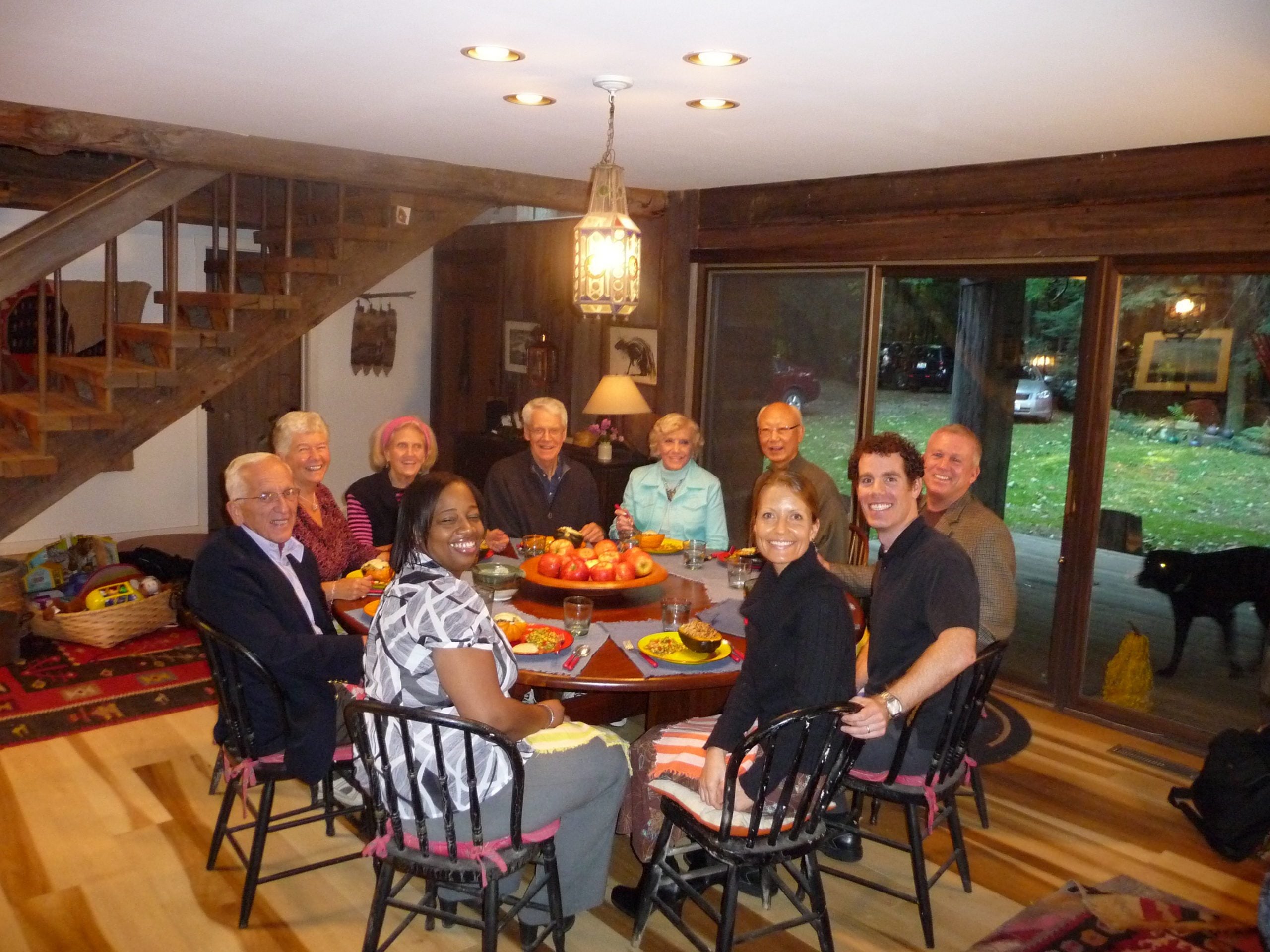 The cast and crew of the Forks Over Knives documentary enjoy a plant-based meal around a circular table, 2009