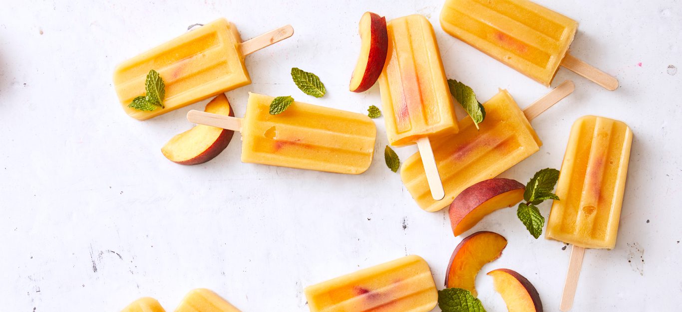 Vegan Peaches and Cream Ice Pops on a white countertop
