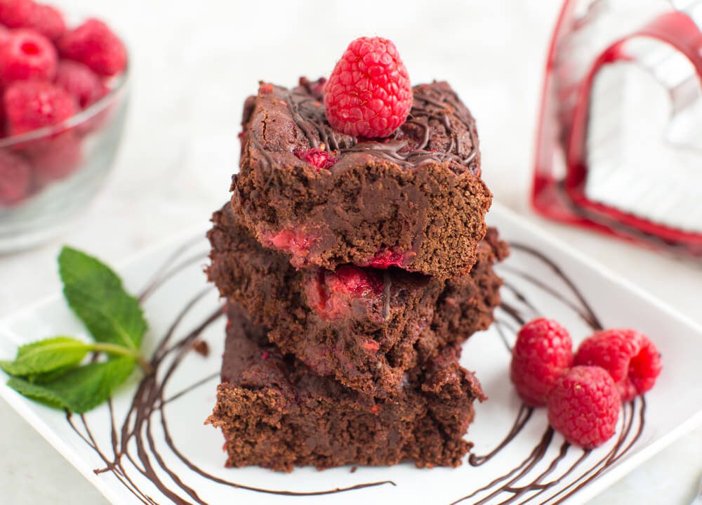 Raspberry Brownies Recipe: These dense, fudgy raspberry brownies have loads and loads of melt-in-your-mouth raspberry yumminess!