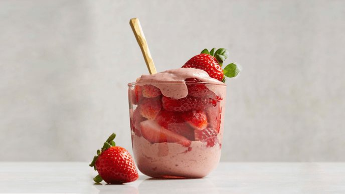 Glass parfait jar with strawberries and cream