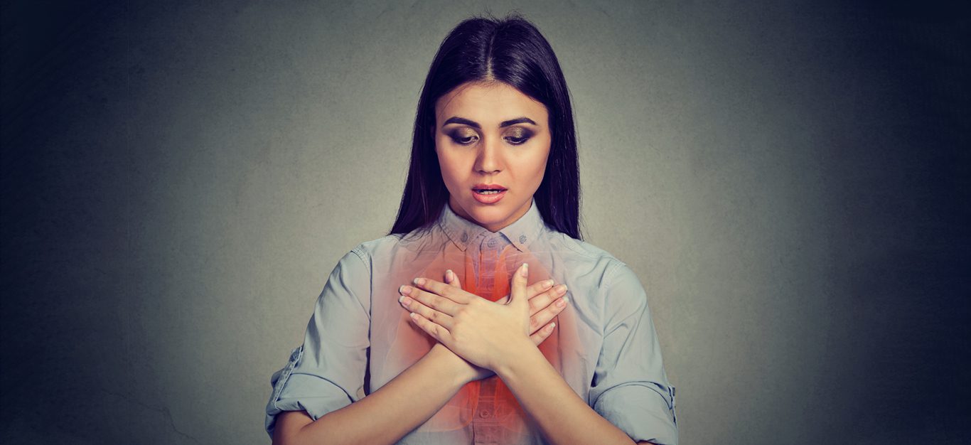Asthma and diet - woman with hands over chest