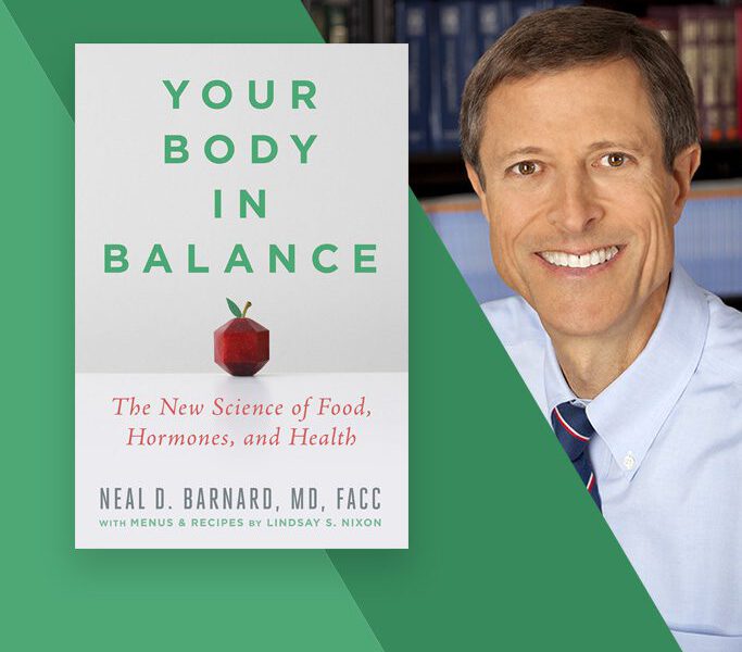 Neal Barnard next to a copy of his book "Your Body in Balance"