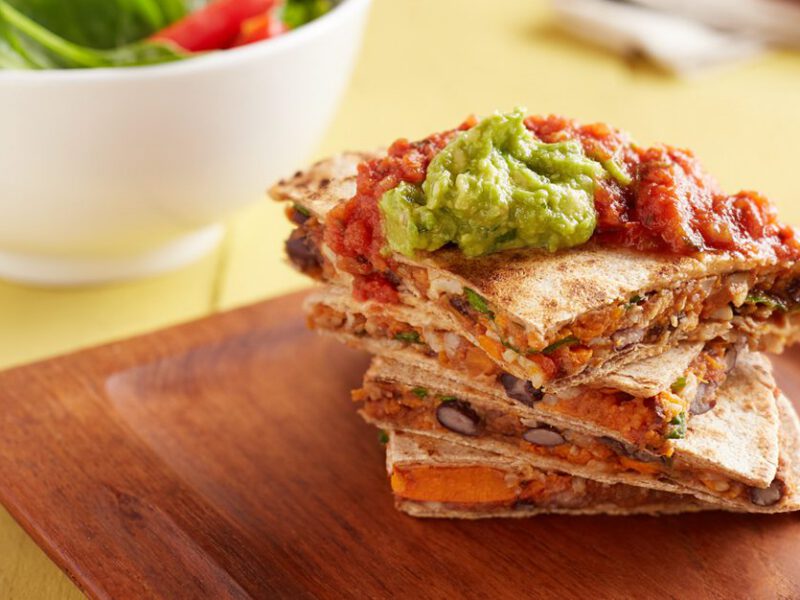 sweet potato quesadilla topped with guacamole - one of many plant based recipes