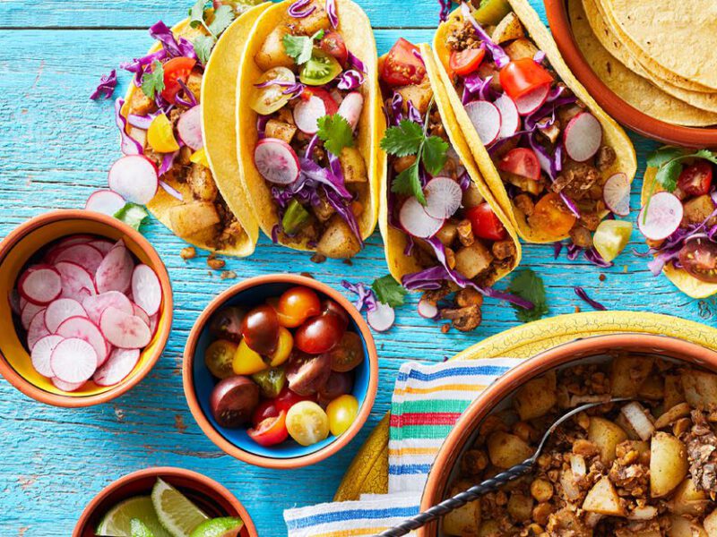 Plant-based tacos with a mushroom chorizo filling served on a blue table