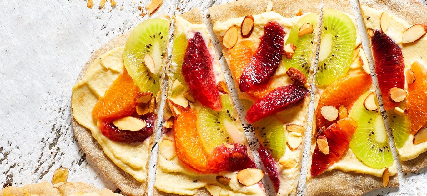 flatbreads with sliced kiwi and oranges
