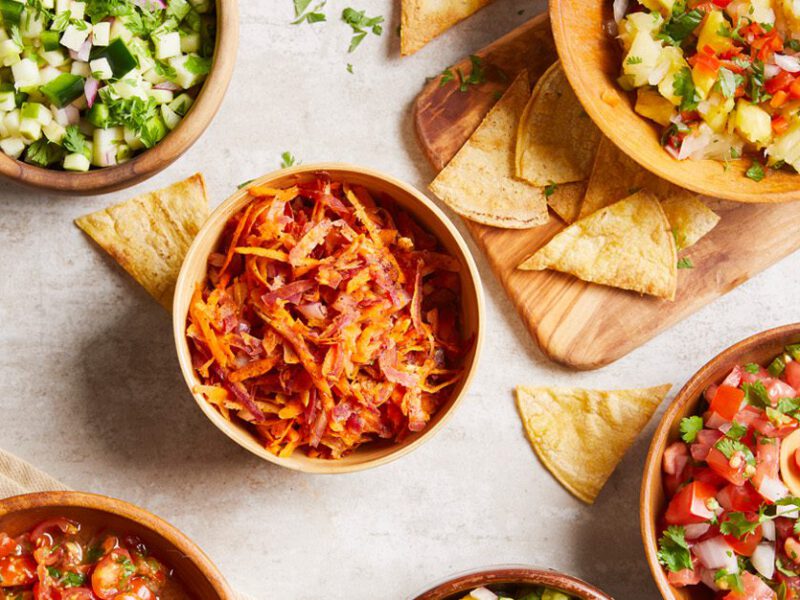 Looking down at a table of different bowls filled a variety of appetizing healthy vegan salads