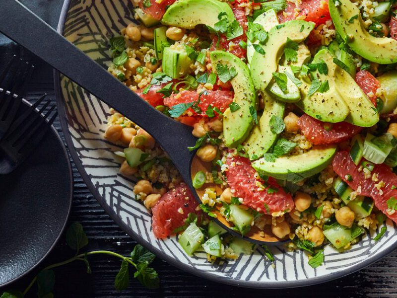 Freekeh grapefruit tabbouleh salad - avocado and grapefruit slices atop a colorful tabbouleh inspired salad