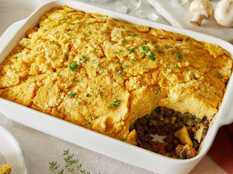 A white casserole dish of Vegan Shepherd's Pie with Polenta and Lentils