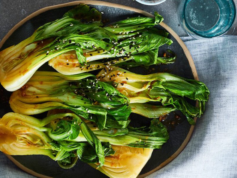 A plate of six bok choy halves in ginger garlic sauce
