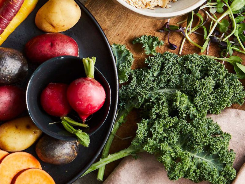 fall and winter fruits and veggies - kale, beets, sweet potato shown on wood table