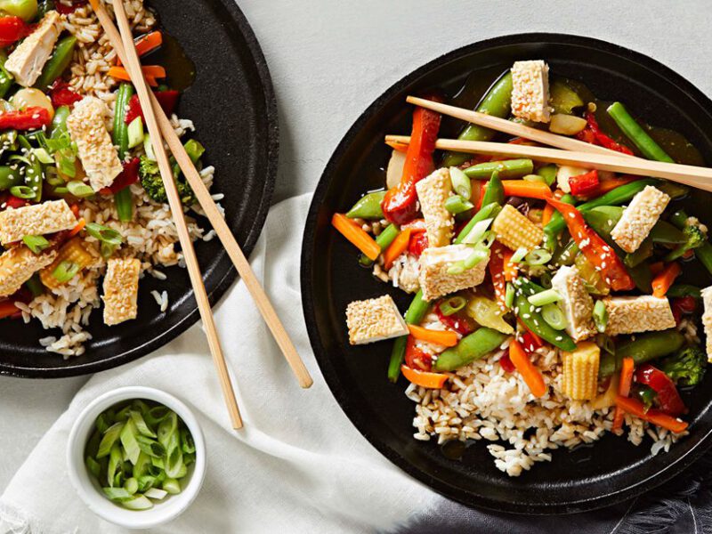 Air-Fryer Vegan Dish - Colorful Stir-Fry Dish with Veggies and Crispy Golden Sesame-Encrusted Tofu