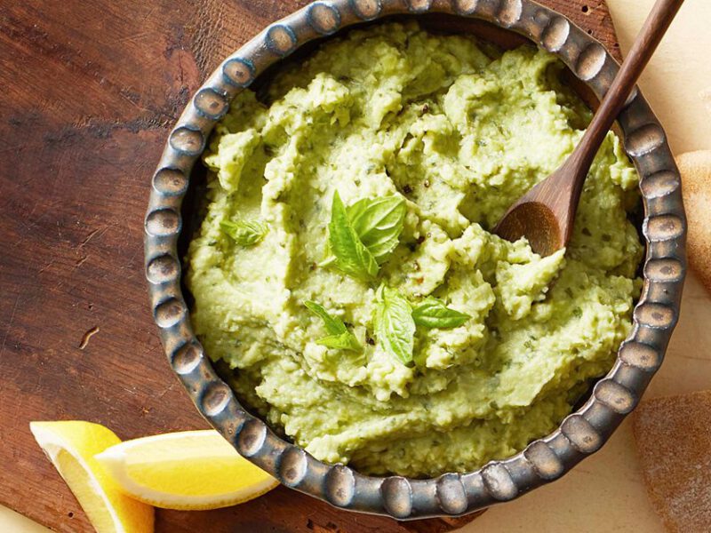 Lima bean hummus - green hummus with basil shown with pita chips