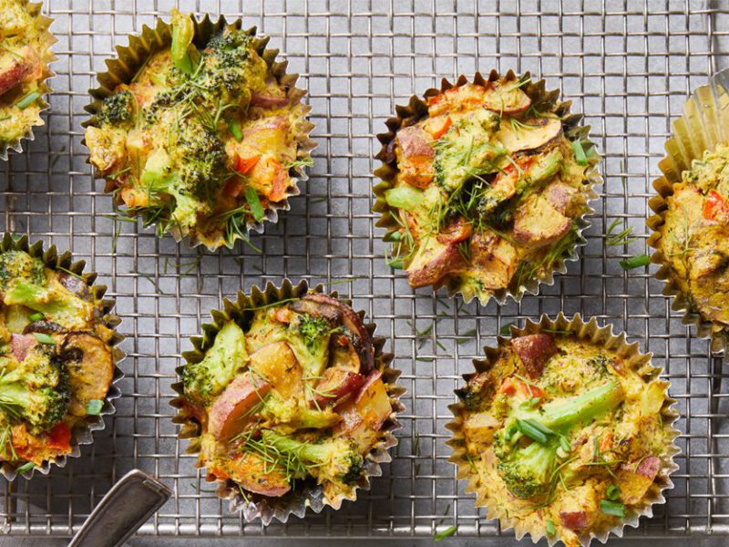 an array of mini frittatas in muffin tin cups with potato and broccoli - vegan scramble