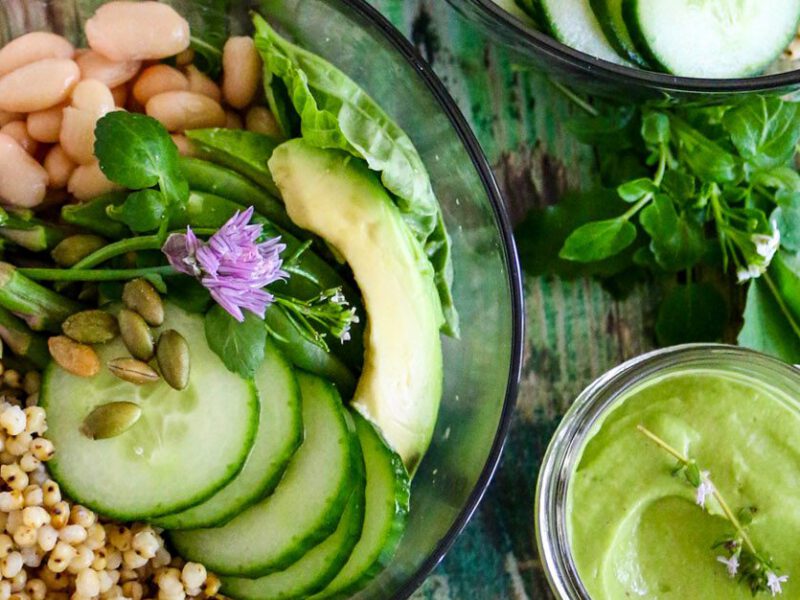 Green Goddess Grain Bowl with cucumber, asparagus, white beans and sorghum and a small dish of Green Goddess Dressing