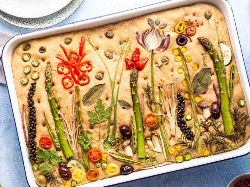 Festive Oil-Free Sourdough Focaccia Bread - An 8x13 focaccia decorated with herbs and vegetables to make a springtime landscape