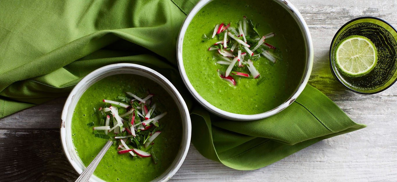 Spring Greens Soup: Two bowls of bright green chilled soup, topped with matchstick-cut radishes