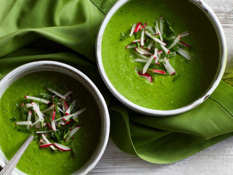 Spring Greens Soup: Two bowls of bright green chilled soup, topped with matchstick-cut radishes