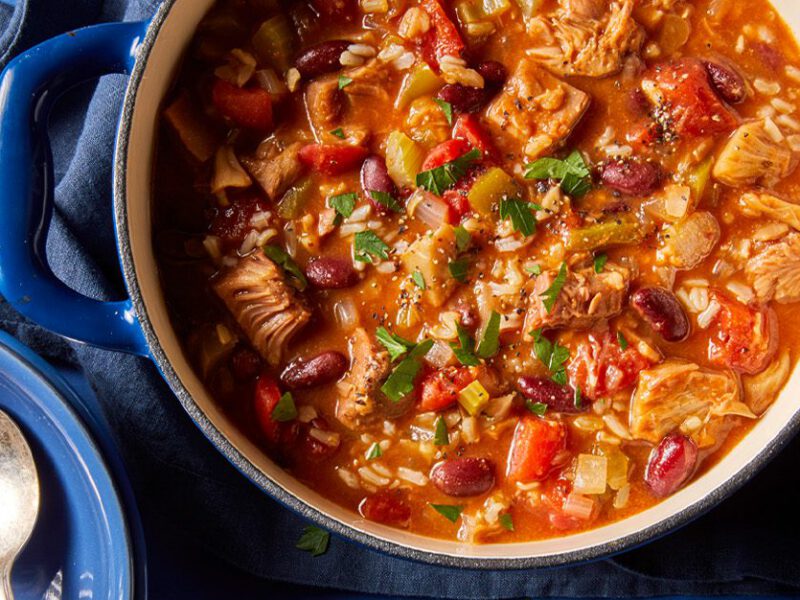 Jackfruit Vegan Jambalaya in a large pot with a spoon to the side - Hearty vegan fall stew