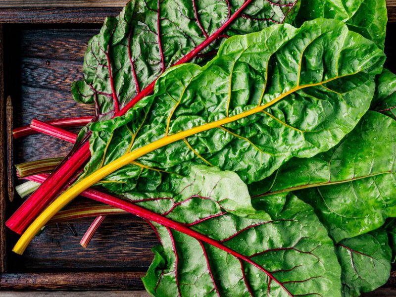 Swiss chard in a wood crate on a wood table