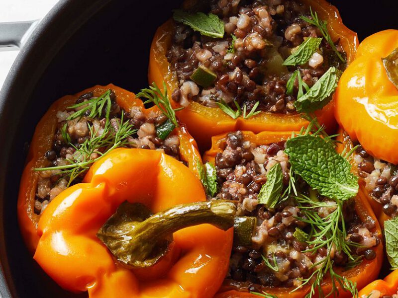 Vegan Stuffed Bell Peppers with Lentils and Herbed Rice in a cast iron skillet
