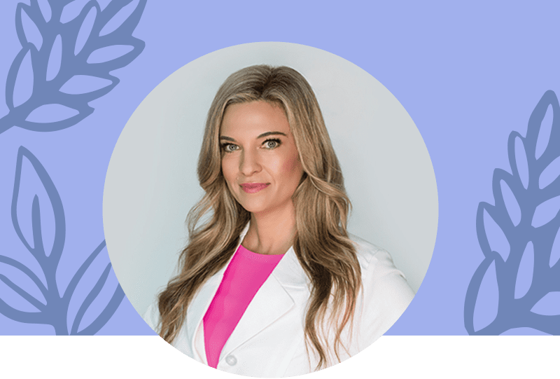 Headshot of Dr. Kristi Funk in a white lab coat with a pink t-shirt