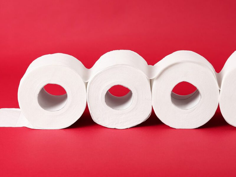 Toilet paper on red background