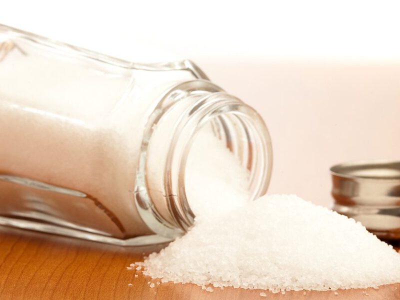 salt shaker spilled out onto a wooden table