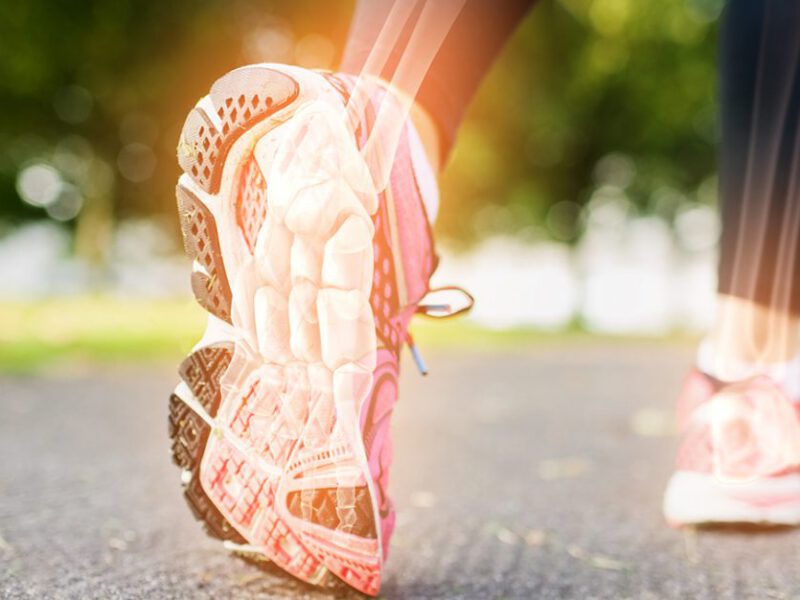 Highlighted bones of woman jogging on grass, showcasing stronger bones as a benefit of reducing sodium