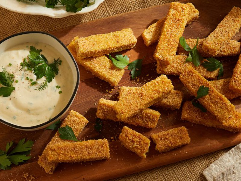 Crispy Baked Polenta Sticks with Ranch Dip on a wooden platter