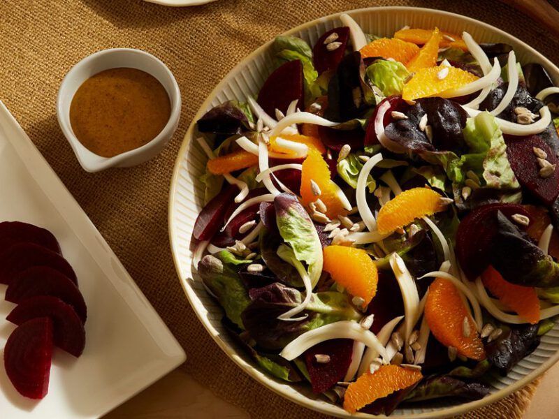 Fennel, Orange, and Beet Salad with Maple Mustard Dressing in a shallow serving bowl