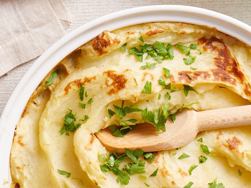 Budget-Friendly Shepherd’s Pie in a white bowl with a wooden spoon