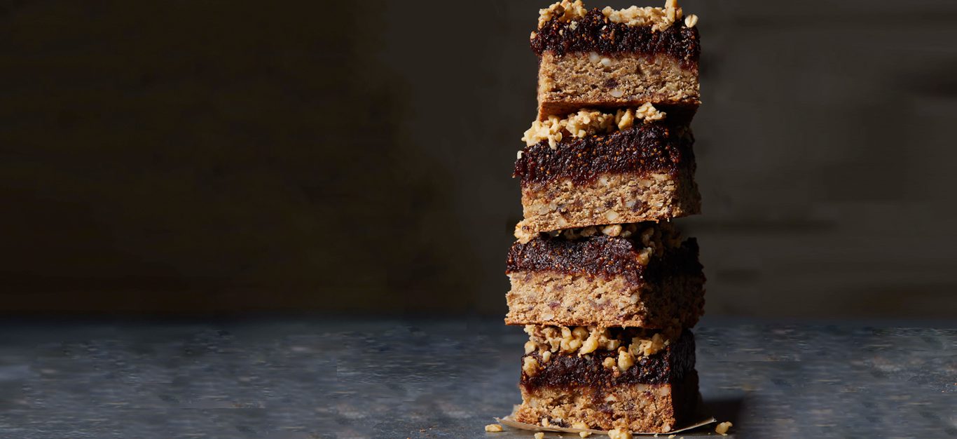 A stack of gluten-free fig bars against a dark background
