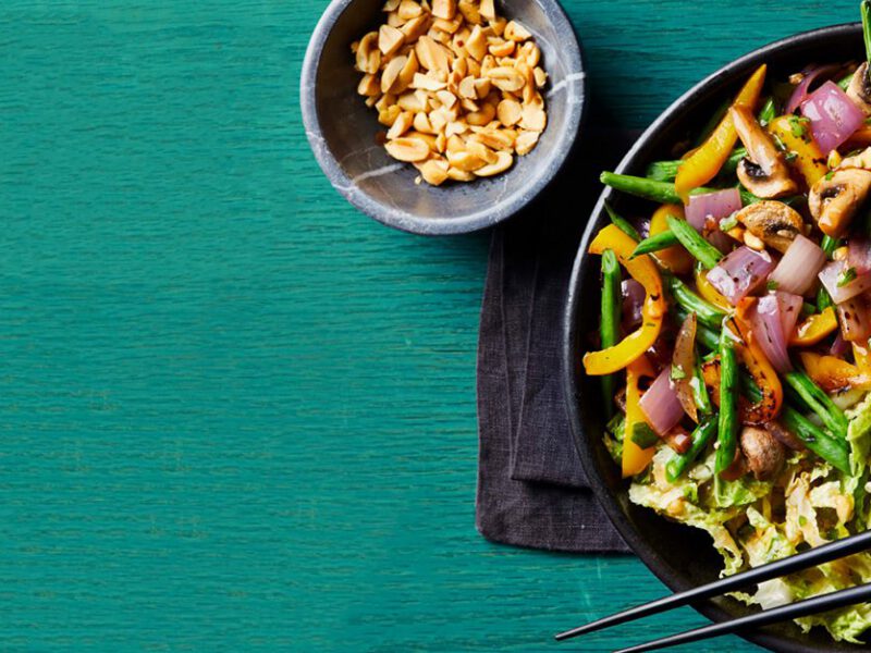 Thai Grain Bowls with black chopsticks on a blue wood table